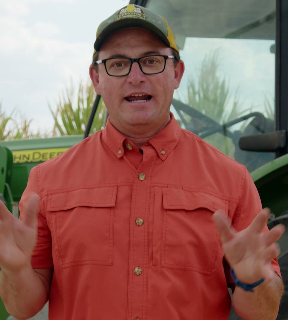 Farmer Bob standing in front of his tractor on the farm